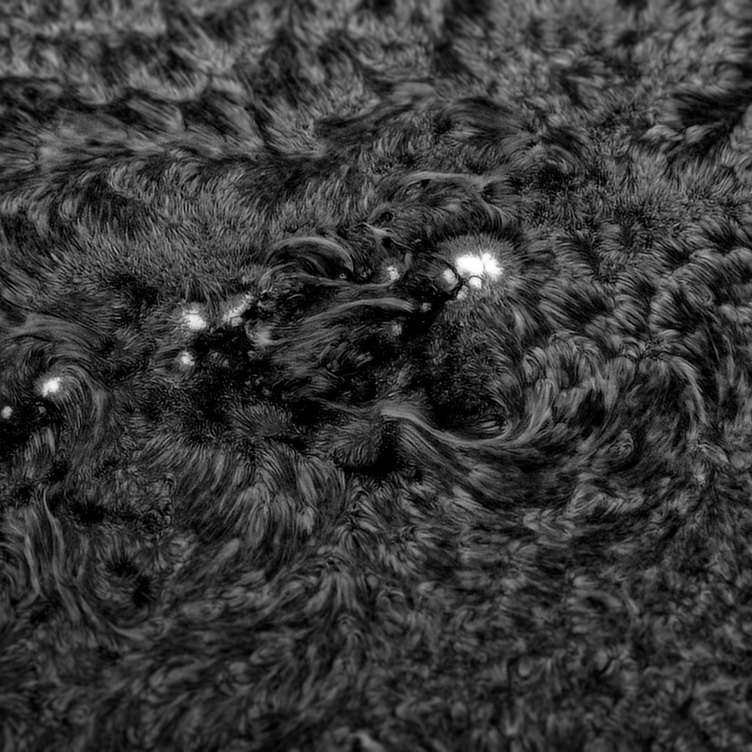 Monochrome solar surface granulation and bright plage around an active region